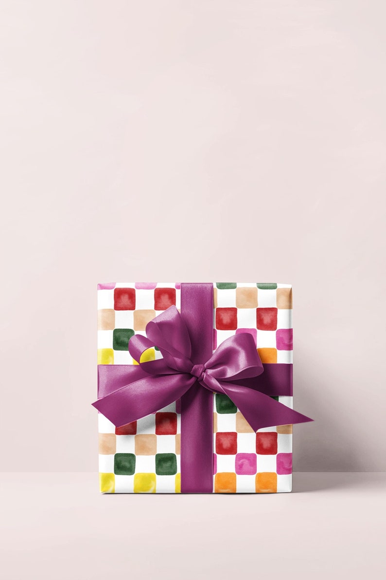 May include: A gift box wrapped in colorful checkered paper with a purple ribbon tied in a bow.