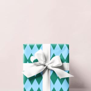 May include: A wrapped gift box with a white ribbon and bow. The wrapping paper has a blue and green diamond pattern. The bow is centered on the top of the box.