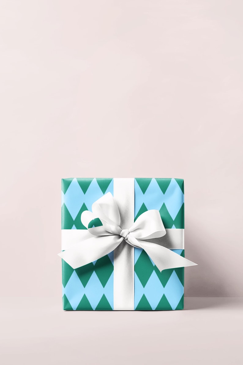May include: A wrapped gift box with a white ribbon and bow. The wrapping paper has a blue and green diamond pattern. The bow is centered on the top of the box.