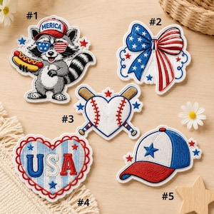 May include: Embroidered patches with patriotic themes. Designs include a raccoon wearing sunglasses and a hat that says "Merica", a bow, a baseball heart, a heart with "USA", and a baseball cap. Each patch has red, white, and blue colours.