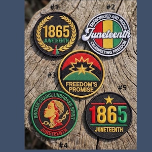 May include: Five Juneteenth patches with various designs. The patches display text and graphics, including the year 1865, the word "Juneteenth," and phrases celebrating freedom. The patches are circular and feature colours such as black, red, green, and yellow.