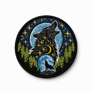 May include: A circular embroidered patch featuring a black wolf silhouette howling at a large blue moon. The design includes a starry night sky, a crescent moon, and green pine trees. The entire scene is framed by a thick black stitched border.