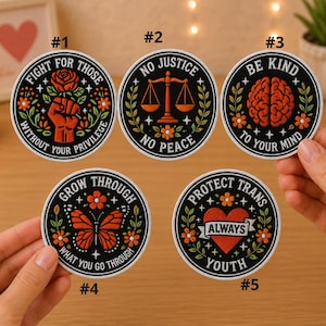 May include: A collection of five round embroidered patches with various designs and text. The patches feature phrases like "Fight for Those," "No Justice No Peace," and "Protect Trans Youth." Each patch has a black background with colorful illustrations.