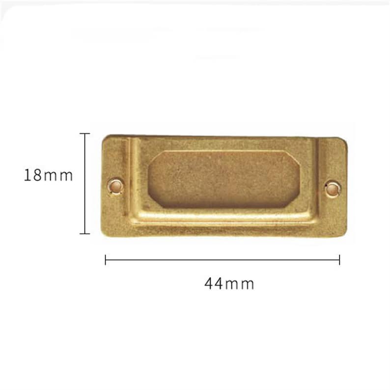 May include: A gold-colored metal label holder with a rectangular shape and rounded corners. It measures 44 mm wide and 18 mm high.