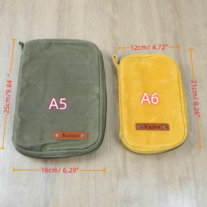 May include: Two zippered pouches, one olive green (16" x 9.84") and one yellow (4.72" x 8.26"). The green pouch is labeled "A5" and the yellow pouch is labeled "A6". Both have a small leather tag with a name.