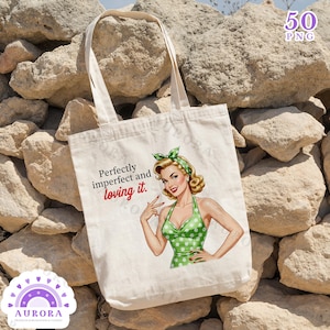 May include: Cream-colored tote bag featuring a retro illustration of a woman in a green polka-dot dress and matching headscarf. The bag has the text "Perfectly imperfect and loving it." The bag has long handles.