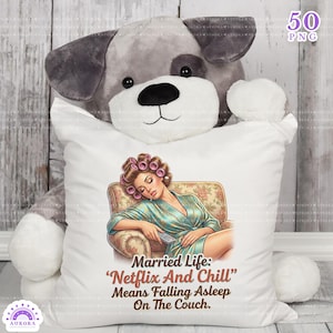 May include: A white pillow with an illustration of a woman in a robe, hair rollers, and a remote control, sleeping on a floral armchair. Text reads "Married Life: 'Netflix And Chill' Means Falling Asleep On The Couch."