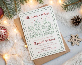 May include: A rectangular white baby shower invitation card with a scalloped green border. The card features a red script header reading It takes a village above a green line drawing of a winter village scene with houses, trees, and a snowman.