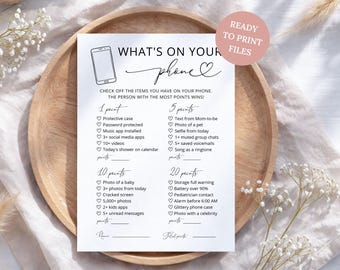 May include: A white paper game card titled What's On Your Phone with a black line drawing of a smartphone. The card lists various items to check off with point values ranging from 1 to 20, including lines for a name and total points at the bottom.