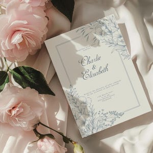 Beautiful wedding invitation mockup highlighted by blue line art floral accents.