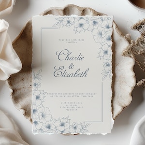 Beautiful wedding invitation mockup highlighted by blue line art floral accents.