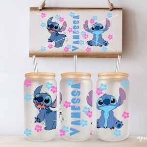 May include: Three frosted glass tumblers with bamboo lids and straws. Each tumbler features a blue Stitch character from Lilo & Stitch, pink and blue flowers, and the name "Vanessa".