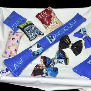 Peut inclure: Un ensemble de jouets pour chat sur le th&egrave;me d'Harry Potter, de couleur bleu et blanc. Les jouets comprennent un long jouet &agrave; chat en catnip bleu avec l'embl&egrave;me de la maison Serdaigle et les mots "Wit Learning Wisdom", un plus petit jouet &agrave; chat en catnip bleu avec l'embl&egrave;me de la maison Serdaigle, un jouet &agrave; chat en catnip rose et blanc &agrave; pois, un jouet &agrave; chat en catnip bleu et blanc avec l'embl&egrave;me de Poudlard, un jouet &agrave; chat en catnip bleu et blanc avec la carte du Maraudeur, et trois n&oelig;uds papillon bleu et blanc avec l'embl&egrave;me de la maison Serdaigle.