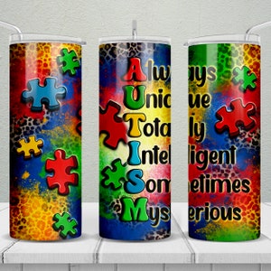 May include: Three colorful stainless steel tumblers with a leopard print background and puzzle pieces. The tumblers have the words "Always Unique Totally Intelligent Sometimes Mysterious" written on them.