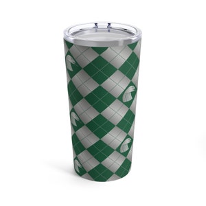 May include: A green and silver tumbler with a repeating pattern of a snake head and a diamond pattern.