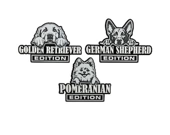 May include: Three dog breed designs: Golden Retriever, German Shepherd, and Pomeranian. Each design features a grayscale illustration of the dog breed above the breed name and the word "Edition" in a black and white rectangular frame.