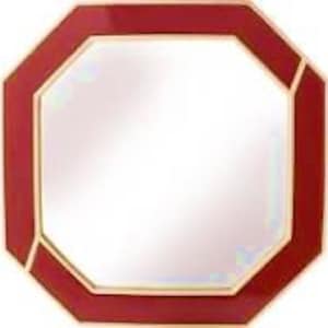 May include: An octagonal wall mirror featuring a glossy, deep red frame with thin gold-toned metallic trim along the inner and outer edges. The reflective glass surface is clear and centered within the geometric, eight-sided red border.