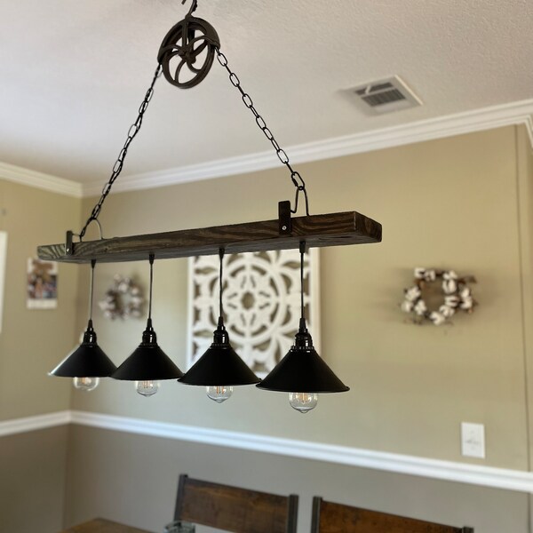 Pendant light fixture with rustic pulley.