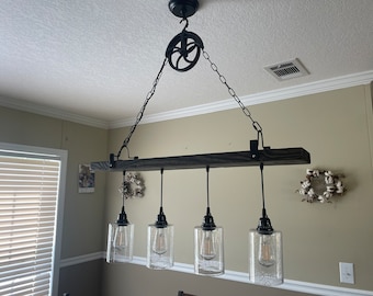 Pendant light fixture with rustic pulley.