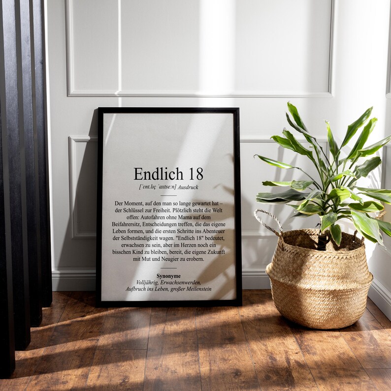 May include: A black framed print with a white background and black text. The text reads "Endlich 18 (ent.les axtsen) Ausdruck" and continues with a definition of the German word "Endlich 18".