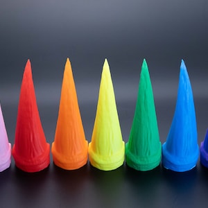 May include: Ten colourful, pointed, cone-shaped objects made of plastic. The colours are white, pink, red, orange, yellow, green, blue, purple, and black.
