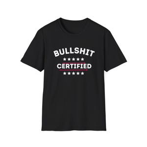 May include: Black t-shirt with the words "BULLSHIT CERTIFIED" in white, with red accents and star graphics. The text is centered on the front of the shirt.