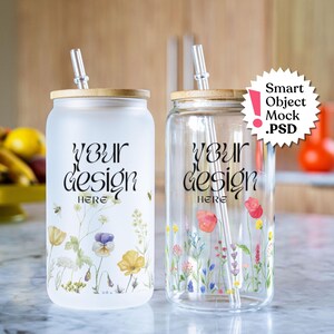 May include: Two glass tumblers with bamboo lids and clear straws. Both tumblers have a floral design and the text "Your Design Here" printed on them. The tumblers are on a white countertop.