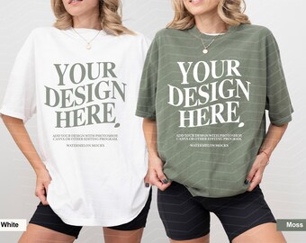 May include: Two oversized t-shirts, one white and one moss green, each featuring the text "YOUR DESIGN HERE" in a large serif font, followed by "ADD YOUR DESIGN WITH PHOTOSHOP, CANVA OR OTHER EDITING PROGRAM" and "WATERMELON MOCKS" in smaller text.
