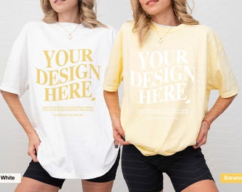May include: Two oversized t-shirts, one white with gold text and one banana yellow with white text. Both shirts feature the printed words YOUR DESIGN HERE and smaller instructional text below, paired with black athletic shorts.