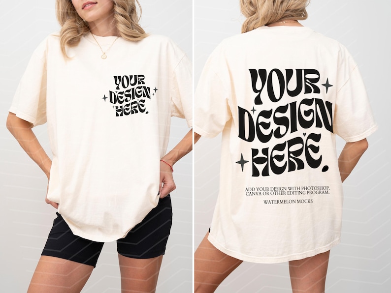 May include: An oversized white t-shirt with the text "YOUR + DESIGN + HERE" on the front and "YOUR + DESIGN + HERE" on the back. The text is in a retro font style. The t-shirt is being modelled by a person wearing black shorts.