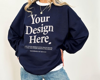 May include: A navy blue crewneck sweatshirt featuring the white text Your Design Here, with additional smaller text below reading ADD YOUR DESIGN WITH PHOTOSHOP, CANVA OR OTHER EDITING PROGRAM and WATERMELON MOCKS, worn over a white shirt.
