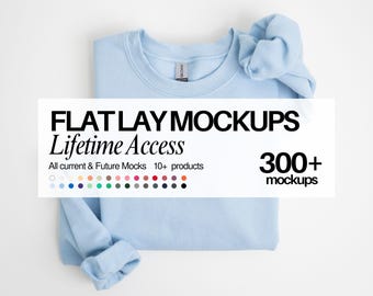 May include: A light blue crewneck sweatshirt with a matching scrunchie. A white overlay displays the text: FLAT LAY MOCKUPS Lifetime Access, 300+ mockups, All current & Future Mocks, 10+ products, and a grid of small colored circles.