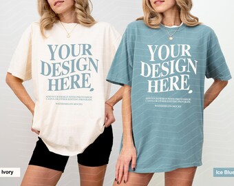 May include: Two oversized crewneck t-shirts in ivory and ice blue, each featuring the text YOUR DESIGN HERE in a large serif font, with smaller instructional text below regarding Photoshop and Canva editing programs for digital mockups.