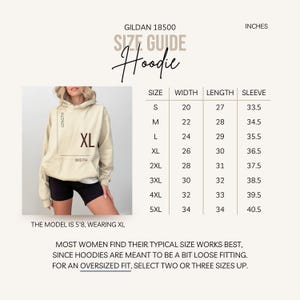 May include: Size chart for a Gildan 18500 hoodie in inches. The chart shows the width, length, and sleeve length for sizes S through 5XL. The model is wearing a size XL.