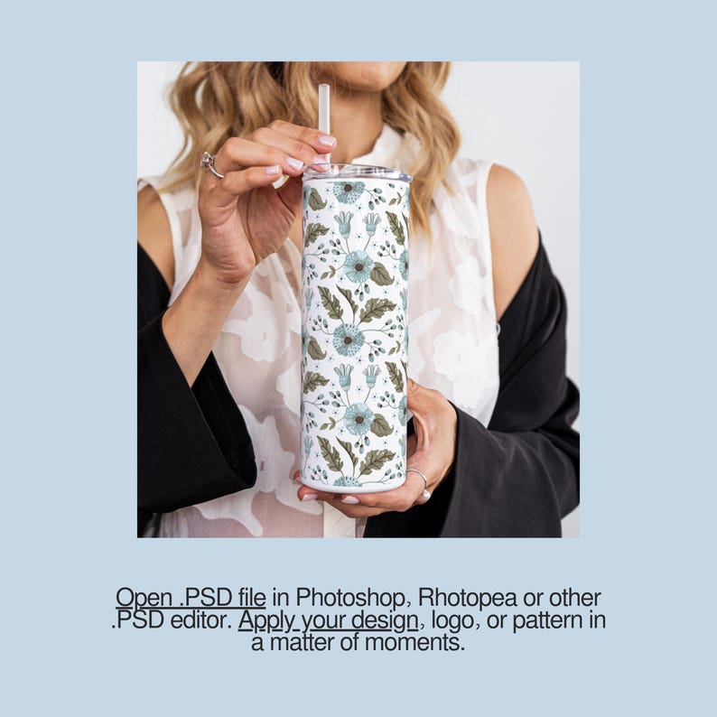 a woman holding a cup with a flower pattern on it