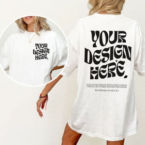May include: White oversized t-shirt with a black graphic that says "YOUR DESIGN HERE."  The graphic is in a retro font style.  The text "ADD YOUR DESIGN WITH PHOTOSHOP, CANVA OR OTHER EDITING PROGRAM. WATERMELON MOCKS" is printed below the graphic.