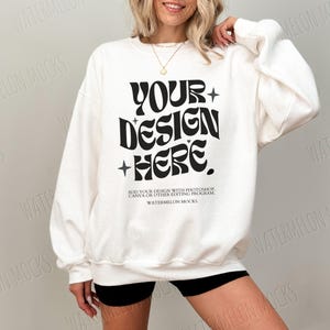 May include: White sweatshirt with a black graphic that says "YOUR+DESIGN+HERE."  The text is in a retro font style.  The text below the graphic says "ADD YOUR DESIGN WITH PHOTOSHOP, CANVA OR OTHER EDITING PROGRAM. WATERMELON MOCKS."
