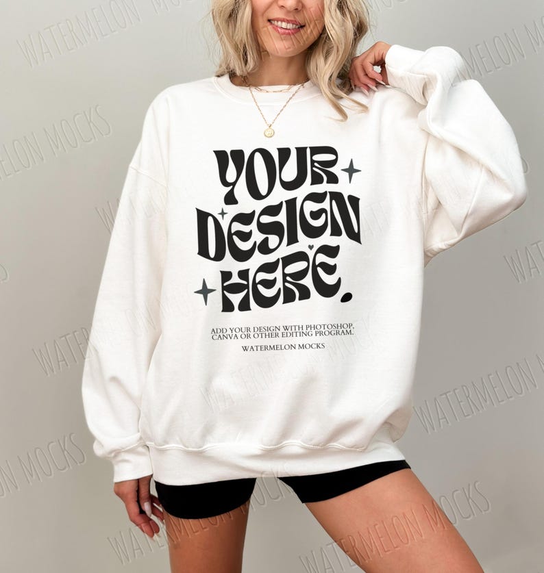 May include: White sweatshirt with a black graphic that says "YOUR+DESIGN+HERE."  The text is in a retro font style.  The text below the graphic says "ADD YOUR DESIGN WITH PHOTOSHOP, CANVA OR OTHER EDITING PROGRAM. WATERMELON MOCKS."