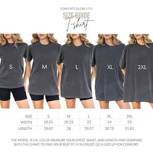 May include: A Comfort Colors 1717 charcoal grey t-shirt size guide showing five sizes from S to 2XL. The chart lists widths from 18.25 to 26 inches and lengths from 26.62 to 31.62 inches. Text includes: Comfort Colors 1717, Size Guide, T-shirt, Inches.