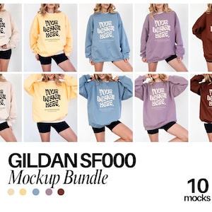Pode incluir: Um pacote de maquetes de dez sweatshirts Gildan SF000 em várias cores, incluindo bege, amarelo, azul, roxo e castanho. Cada sweatshirt exibe o texto "YOUR DESIGN HERE" em uma fonte retrô. Os sweatshirts são combinados com shorts pretos.