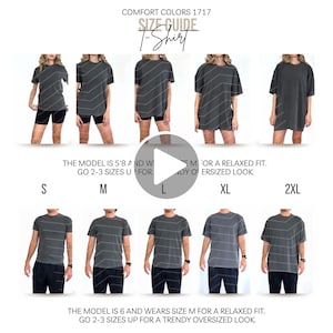 May include: A Comfort Colors 1717 t-shirt size guide displaying five charcoal grey shirts in sizes S, M, L, XL, and 2XL. The text reads: COMFORT COLORS 1717 SIZE GUIDE T-Shirt. THE MODEL IS 5'8 AND WEARS SIZE M FOR A RELAXED FIT. GO 2-3 SIZES UP FOR A TRENDY OVERSIZED LOOK.