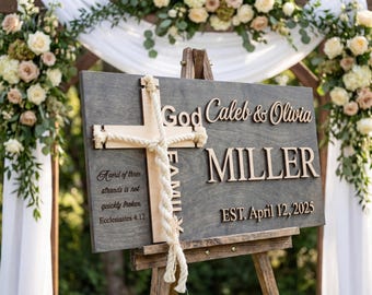 May include: A wooden wedding sign with the names "Caleb & Olivia Miller" and the date "April 12, 2025". The sign features a cross and a quote from Ecclesiastes. The sign is displayed on a wooden easel, with floral arrangements in the background.