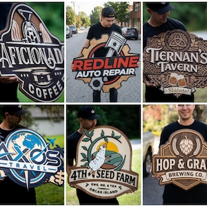 May include: A collection of six custom-made, multi-layered wooden signs featuring various business logos and designs, including Aficionado Coffee, Redline Auto Repair, Tiernan's Tavern, Axos Travel, 4th Seed Farm, and Hop & Grain Brewing Co.