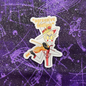 May include: A white sticker with a cartoon character wearing a top hat and playing a violin. The text on the sticker says "*aggressive fiddling*"