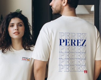 May include: Two people wearing white t-shirts. The person on the left is wearing a t-shirt with the text "Oracle Red Bull Racing" on the front. The person on the right is wearing a t-shirt with the text "Perez" repeated multiple times on the back.