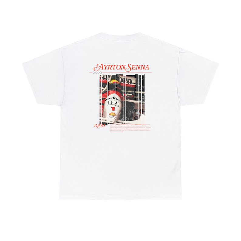 May include: White t-shirt with a red and white image of Ayrton Senna in a race car. The text "Ayrton Senna" and "1960" are printed on the shirt.