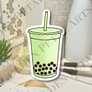 May include: A sticker of a green and white boba tea with a straw and black boba pearls.