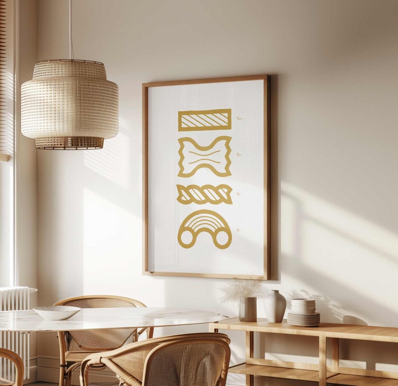 May include: A framed print with a white background and gold illustrations of different types of pasta. The pasta shapes are labeled with their names in a small font.