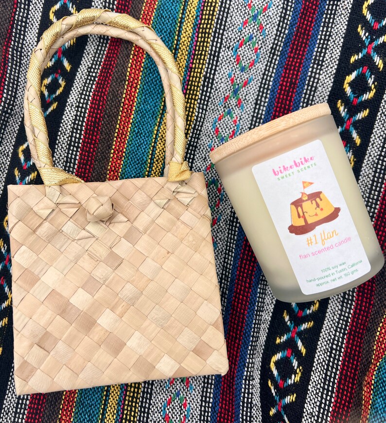 Leche flan soy candle in a glass jar. #1 Flan isa  heavenly blend of custardy goodness harmonizing with the rich flavors of condensed milk, a dash of vanilla, and luscious caramelized sugar. Comes with a Philippine made handwoven pandan bag.