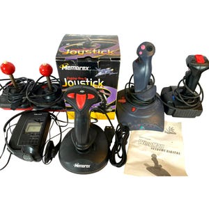 May include: A collection of vintage joysticks and a portable media player. The joysticks are black and gray with red and black accents. One joystick is in its original box. A Logitech WingMan Extreme Digital user's guide is also included.